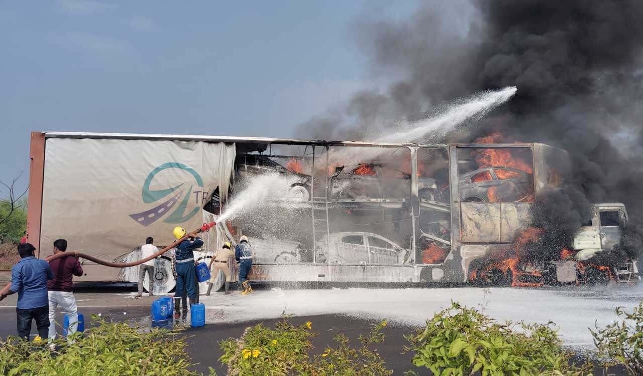 Container lorry with cars catches fire on NH-65 at Zaheerabad